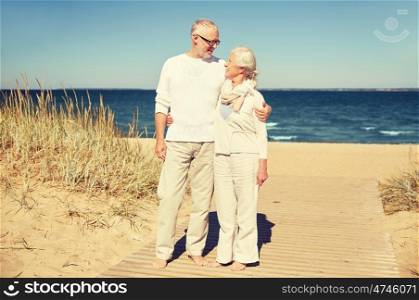 family, age, travel, tourism and people concept - happy senior couple talking on summer beach
