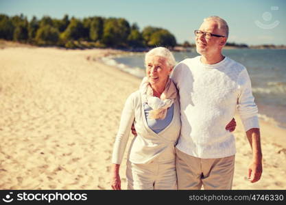 family, age, travel, tourism and people concept - happy senior couple walking along summer beach