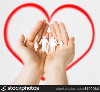 family and happiness concept - man hands showing family of paper men