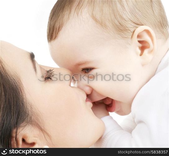 family and happy people concept - mother kissing her baby