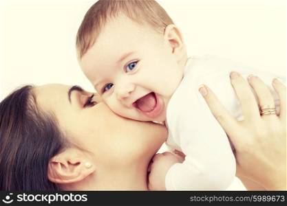 family and happy people concept - mother kissing her baby. mother kissing her baby