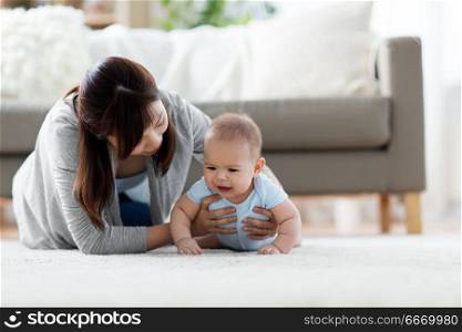family and motherhood concept - asian mother with crying little baby at home. mother with crying little baby boy at home. mother with crying little baby boy at home
