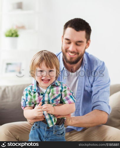 family and people concept - happy father with little son at home. happy father with little son at home