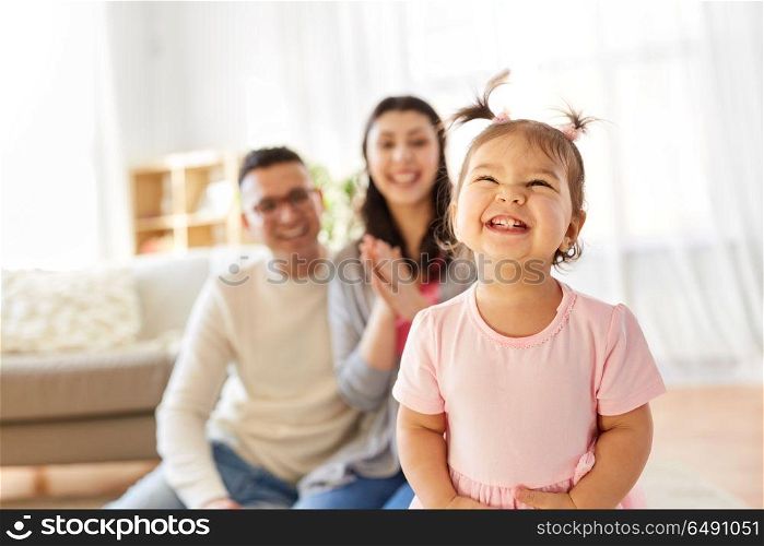 family and people concept - happy little daughter with mother and father at home. happy baby girl and parents at home. happy baby girl and parents at home