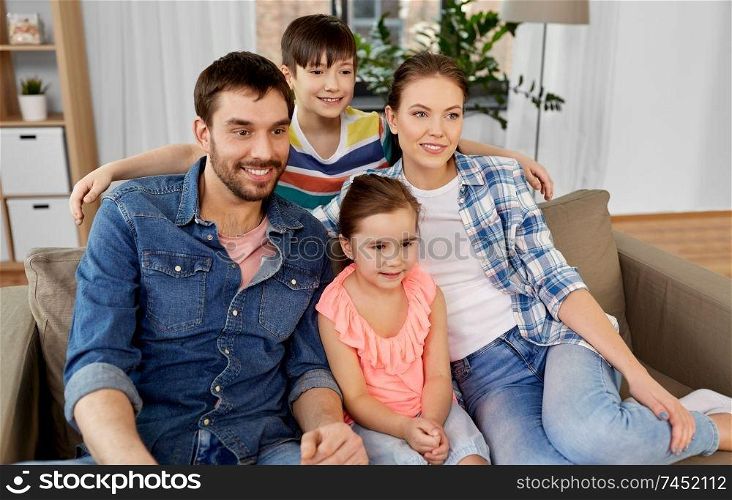 family and people concept - portrait of happy father, mother, little son and daughter at home. portrait of happy family at home