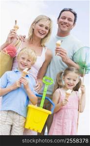 Family at beach with ice cream cones smiling