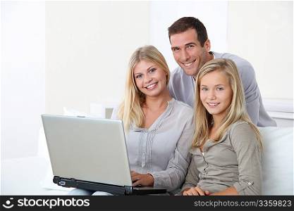 Family at home in front of computer