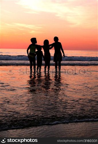 Family at the beach at sunset
