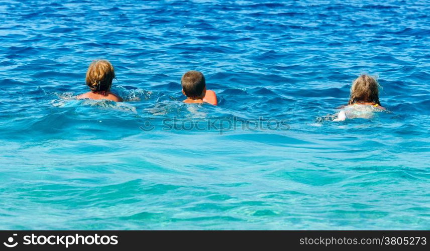 Family bathing in the sea. Summer vacation (Greece, Kefalonia, Beach Antisamos).