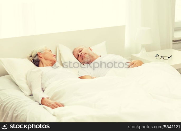 family, bedtime, resting, age and people concept - happy senior coupler lying in bad at home