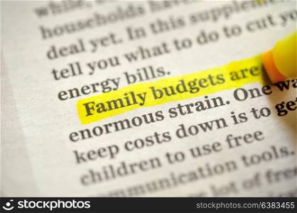 Family budget Using A Highlighter Marker on newspapper