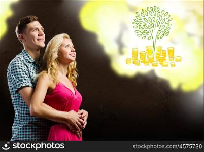 Family budget. Young happy couple dreaming about future life