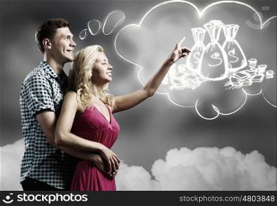 Family budget. Young happy couple dreaming about future life