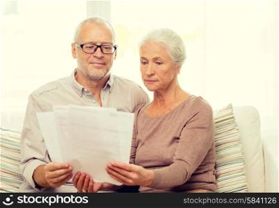 family, business, age and people concept - senior couple with papers at home