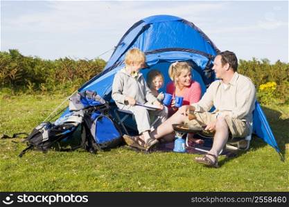 Family camping with tent and cooking