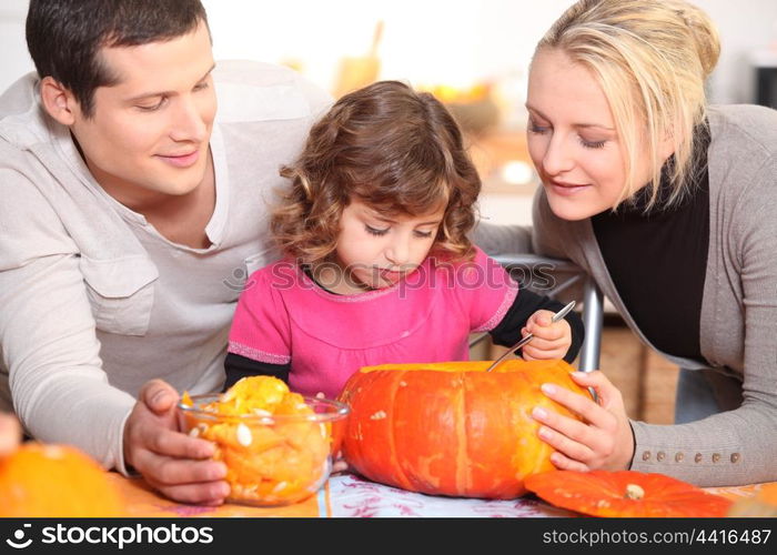 Family carving a pumpkin