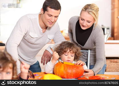 Family carving a pumpkin