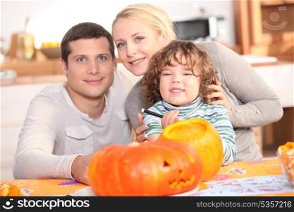 Family carving a pumpkin together