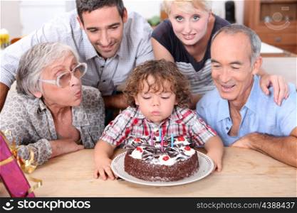 Family celebrating birthday boy