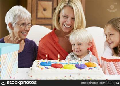 Family Celebrating Children&#39;s Birthday With Grandmother