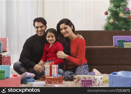 Family Celebrating Christmas with Gifts at home