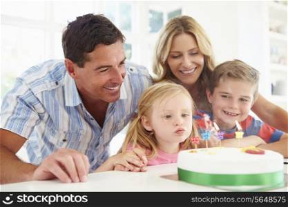 Family Celebrating Daughters Birthday With Cake