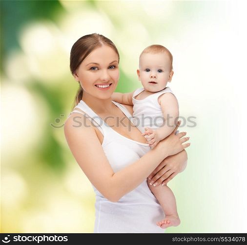 family, child and happiness concept - happy mother with adorable baby