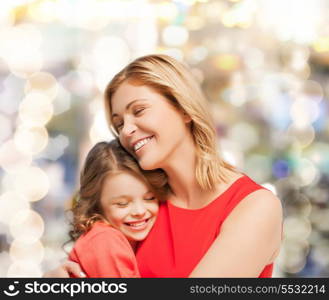 family, child and happiness concept - hugging mother and daughter