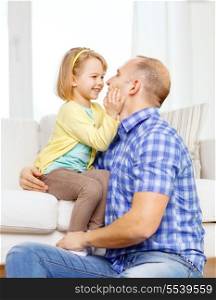 family, child and happiness concept - smiling father and daughter playing at home
