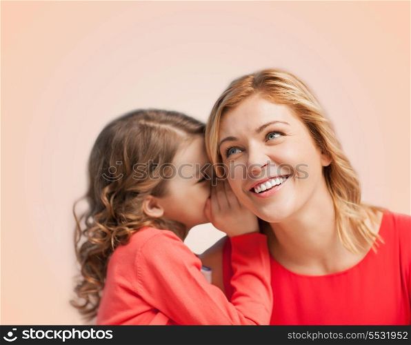 family, child and happiness concept - smiling mother and daughter whispering gossip