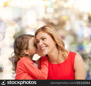 family, child and happiness concept - smiling mother and daughter whispering gossip