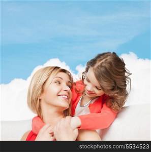 family, child and happiness concpt - hugging mother and daughter