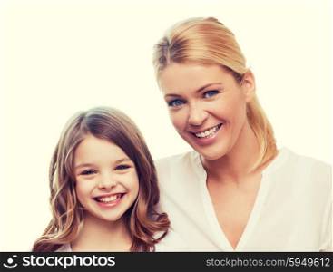 family, child and home concept - smiling mother and little girl at home