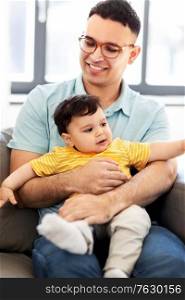 family, child and motherhood concept - happy father with little baby son at home. happy father with little baby son at home