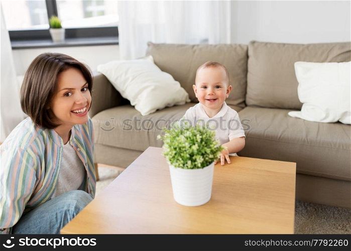family, child and motherhood concept - happy mother with little baby boy at home. happy mother with little baby boy at home