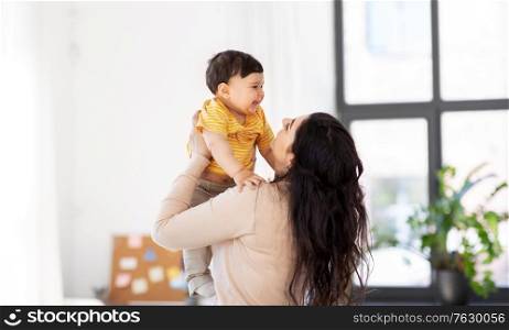 family, child and motherhood concept - happy mother with little baby son at home. happy mother with little baby son at home