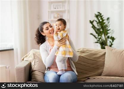 family, child and motherhood concept - happy smiling mother with little baby daughter at home. happy smiling mother with baby daughter at home