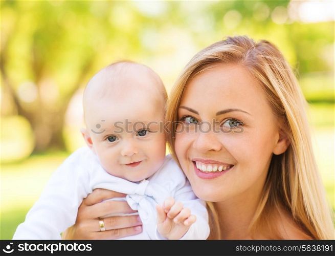 family, child and parenthood concept - close up of happy mother with little baby in park