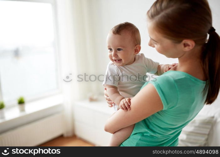 family, child and parenthood concept - close up of happy smiling young mother with little baby at home