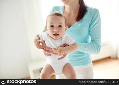 family, child and parenthood concept - close up of happy young mother with little baby at home. happy young mother with little baby at home