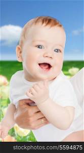 family, child and parenthood concept - close up of mother holding smiling baby