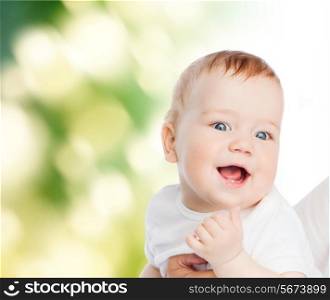 family, child and parenthood concept - close up of mother holding smiling baby