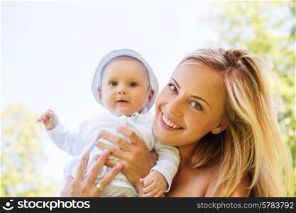 family, child and parenthood concept - happy mother with little baby outdoors