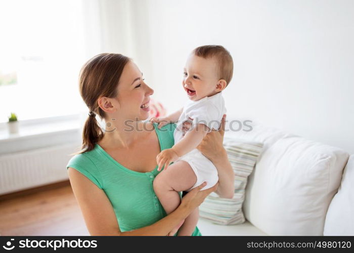 family, child and parenthood concept - happy smiling young mother with little baby at home. happy young mother with little baby at home