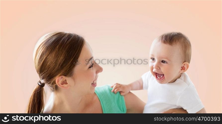 family, child and parenthood concept - happy smiling young mother with little baby over beige background