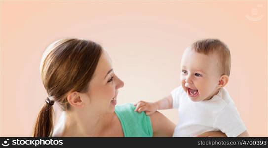 family, child and parenthood concept - happy smiling young mother with little baby over beige background