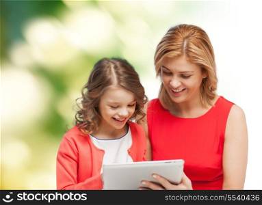 family, child and technology concept - smiling mother and daughter with tablet pc computer