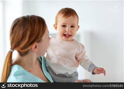 family, childhood and parenthood concept - happy smiling young mother with little baby. happy young mother with little baby
