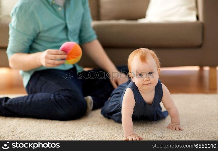 family, childhood and people concept - little red haired baby girl and father at home. little red haired baby girl and father at home. little red haired baby girl and father at home