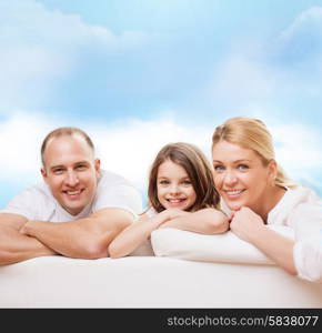 family, childhood and people - smiling mother, father and little girl over blue sky background